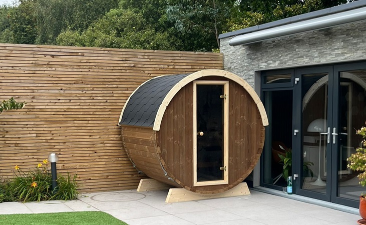 A barrel terrace sauna installed by us in a backyard/patio area