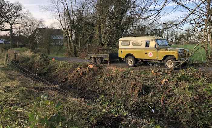 Clearing fallen trees with Landrover in the background