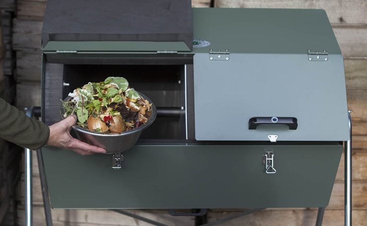 adding food scraps to a Joraform composter
