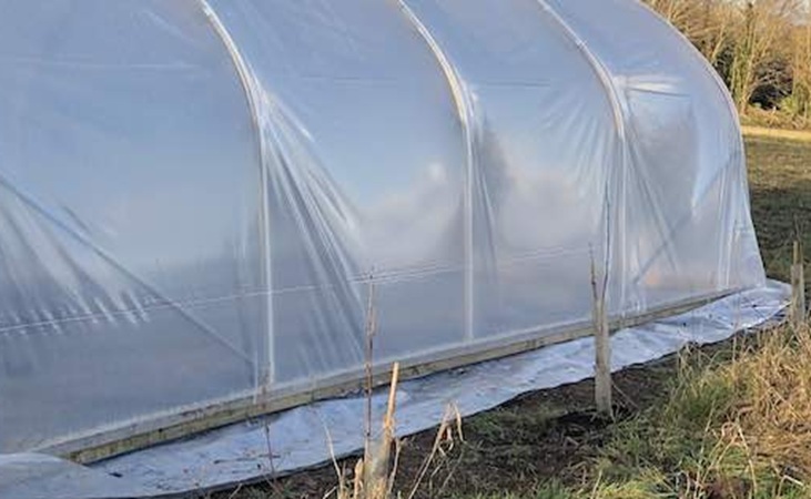 Polythene attached using a base rail system