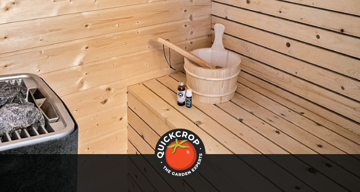 A bucket and ladle on a wooden sauna bench